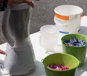 switching on the blender containing shredded paper and water