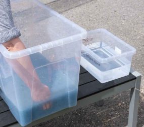 large plastic container filled with blue paper pulp and deckle submerged