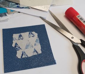 mono print layered on blue textured paper
