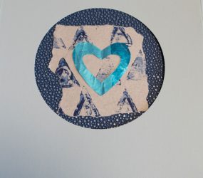 blue heart cutout on blue print background