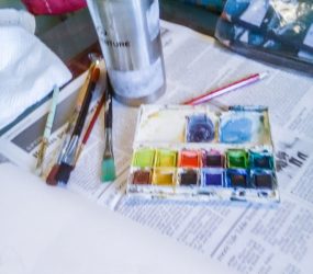 brushes, paints, palette, paper and water pot