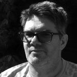 black and white head shot of Jason King