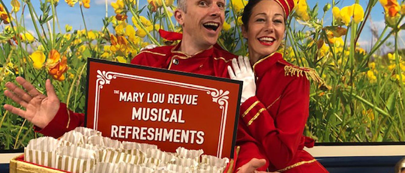 Performers dressed in red as ushers with tray of 'musical refreshments'