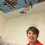 Molly pictured with mobile and ceiling tiles installed