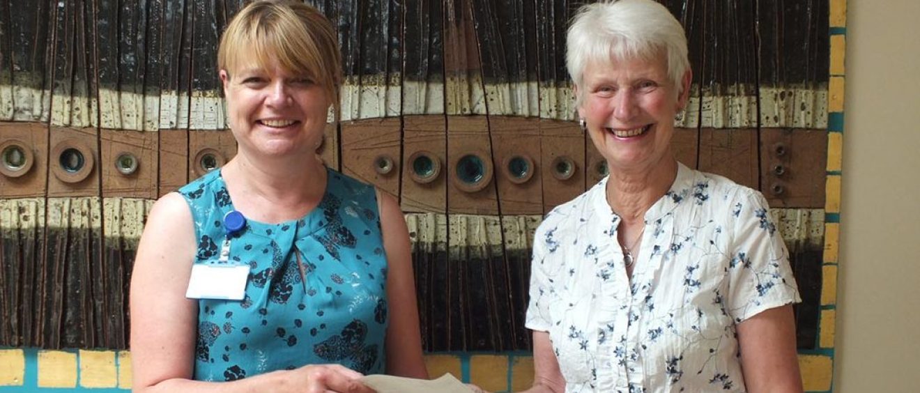 Loraine Sherlock handing cheque to Lesley Self