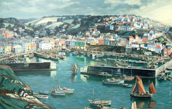 Mevagissey harbour with fishing boats and colourful houses stretching up the hillside
