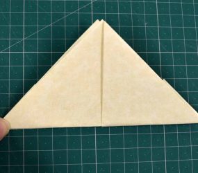 turn over and fold flap up to form triangle shape