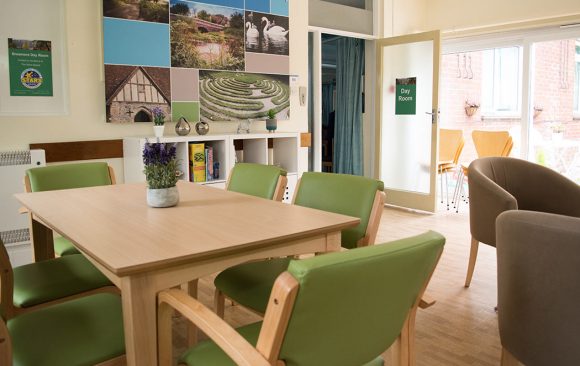 view of dayroom showing montage artwork, new storage unit and table and chairs
