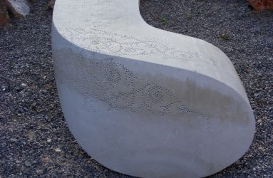 Carved stone seat with surface detail pattern