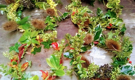 winter wreaths made of holly, leaves, teasel and berries