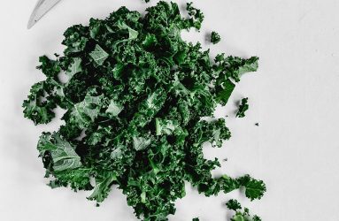 knife next to chopped up kale leaves