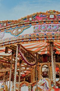 brightly coloured carousel with horses