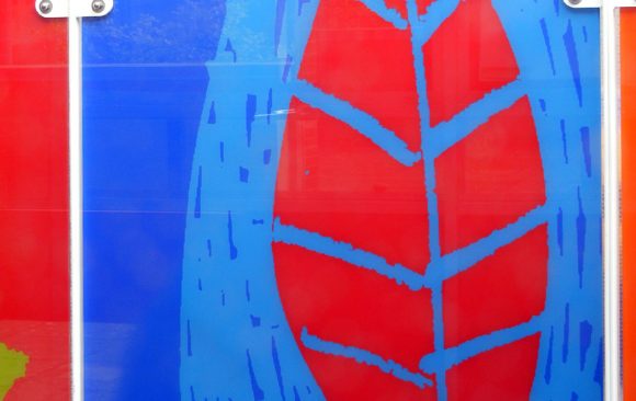 Bright blue glass with red leaf relief design