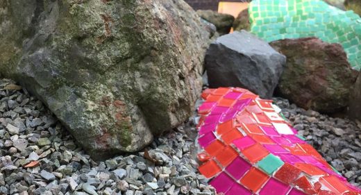 mosaic applied to rock in garden