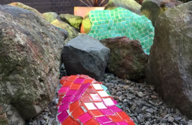 mosaic applied to rock in garden