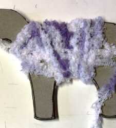 winding purple wool around cardboard sheep template