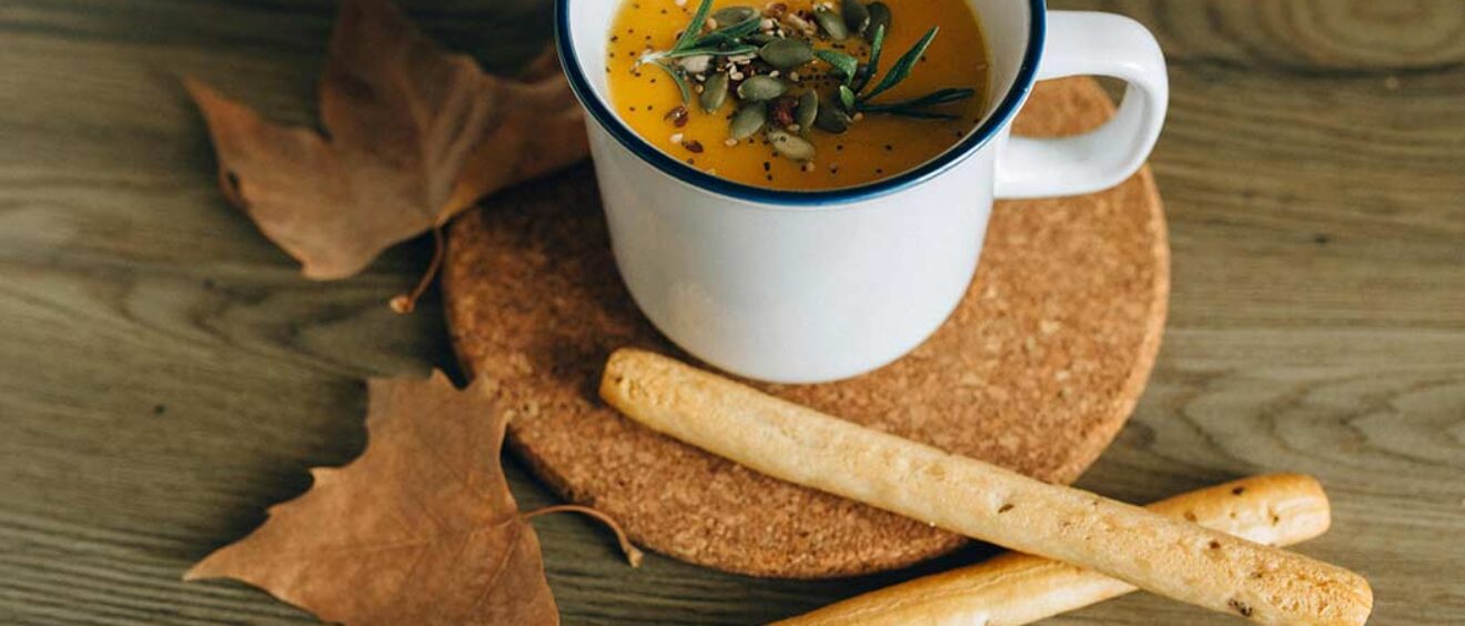 mug of soup and breadsticks