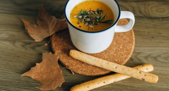 mug of soup and breadsticks